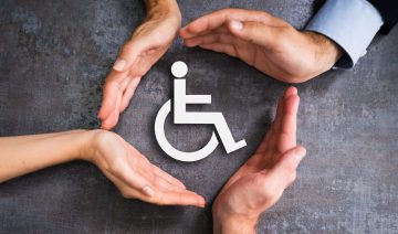 Hands Around Wheelchair Sign — Minka Blue In Bathurst, NSW